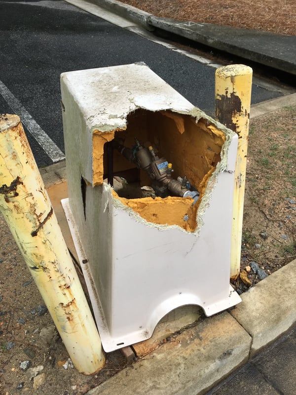 A damaged fiberglass enclosure, not a durable material for high-traffic applications.