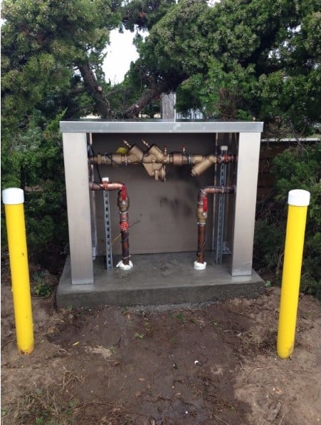 A retrofit aluminum enclosure on an existing RPZ installation.