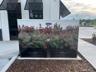 A vinyl wrapped enclosure that mimics a garden flower bed can be a deterrent for graffiti and vandalism.
