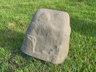 Tan and brown fake rock backflow cover made of plastic or fiberglass, blending with landscaping to deter theft for 2-inch and smaller assemblies.
