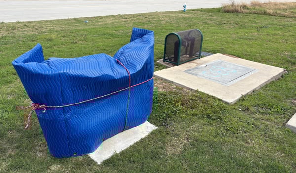 A backflow cage wrapped in a moving blanket to try to protect it from freezing temperatures.