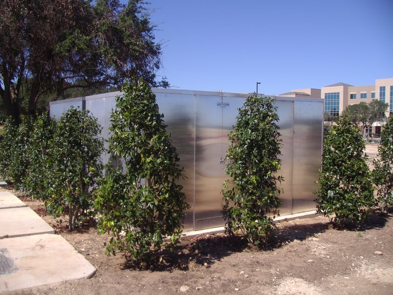A above-ground, marine-grade aluminum enclosure with attractive landscaping trees around it.