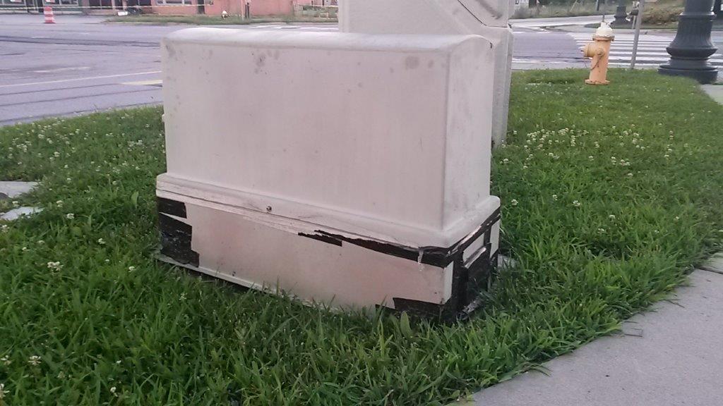 A cracked fiberglass enclosure patched with duct tape