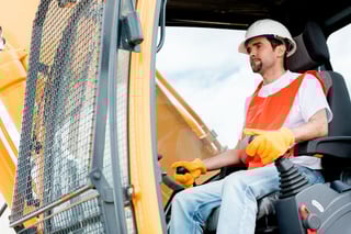 Worker operating a crane at a construction site.jpeg