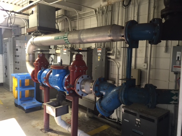 An RPZ backflow prevention assembly installed inside a building