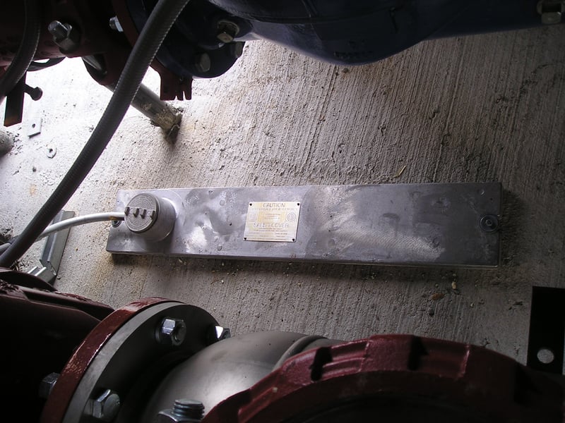 A slab-mounted heater installed on the floor in a backflow enclosure