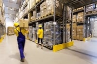 Warehouse worker with box and manager controlling products.jpeg