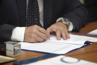 close up of businessman hands signing contract.jpeg