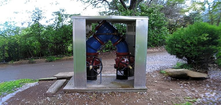 A large enclosure for and RPZ. This RPZ enclosure is open and shows the removable panel options. 