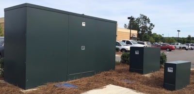 An image of several marine grade aluminum backflow enclosures and a backflow cover over a backflow preventer. This image shows an aluminum enclosure for backflow devices, a backflow cover for a backflow preventer, and several backflow enclosures for frost protection in freezing temperatures to protect riser pipes and backflow devices.