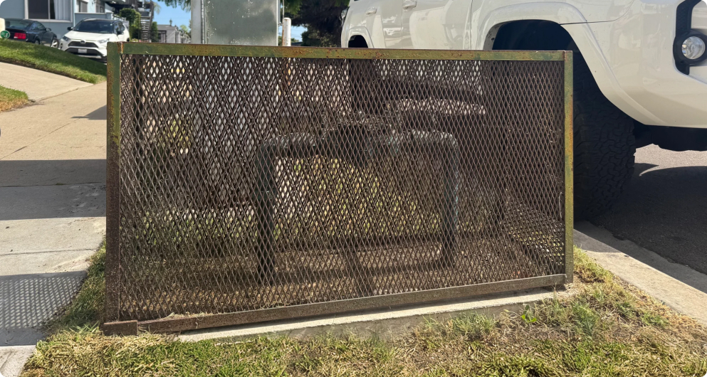 a large square backflow cage that is showing some wear and rust
