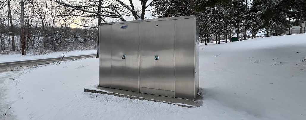 A backflow preventer being protected from a freeze by an enclosure on a concrete skid. 