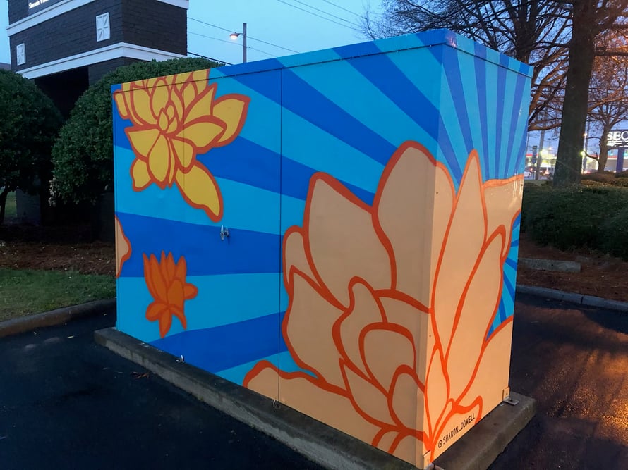 This enclosure is brightened up by custom wrapping featuring work from a local artist